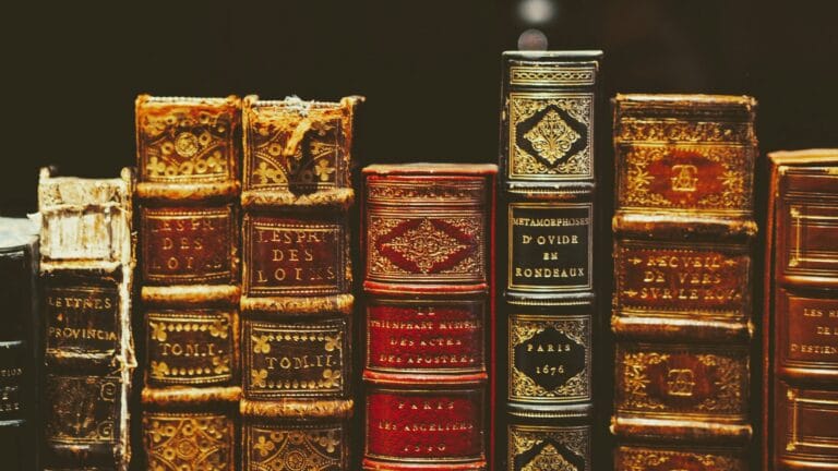 seven hardbound books on black surface stockpack unsplash