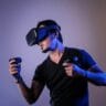 man in black crew neck t shirt wearing black sunglasses holding black smartphone stockpack unsplash