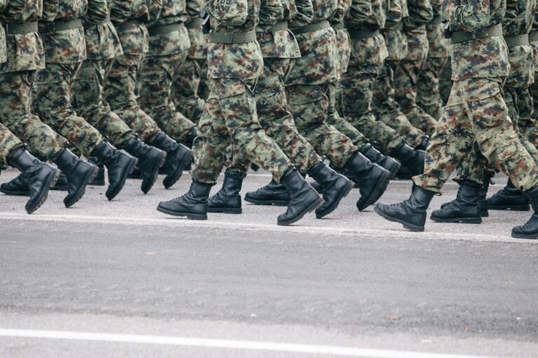 soldiers dressed in army camouflage march in formation stockpack unsplash