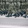 soldiers dressed in army camouflage march in formation stockpack unsplash