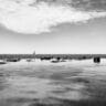 a black and white photo of rocks in the water stockpack unsplash