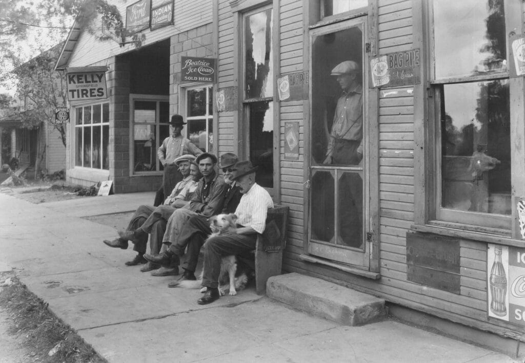 Men With Dog Sitting On Bench In Front Of General Store Date: c. 1910 Artist: Lewis Wickes Hine American, 1874–1940 https://www.artic.edu/artworks/11334/men-with-dog-sitting-on-bench-in-front-of-general-store